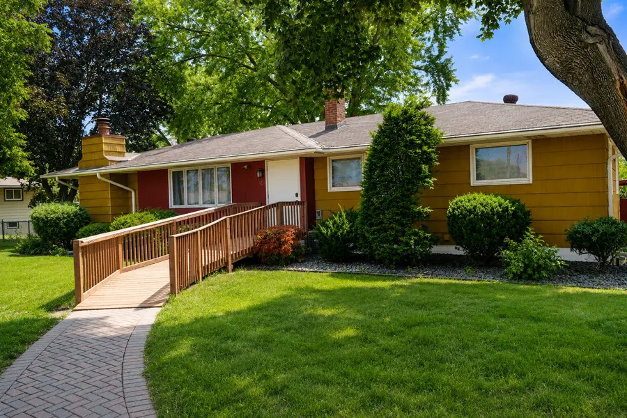Wheelchair-accessible assisted living home with an entrance ramp and welcoming landscaping in Minnesota